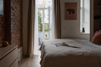 a bedroom with a bed and a large window at Apartment Dalimilova in Prague