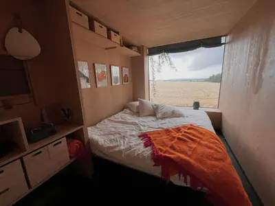 a small bedroom with a bed and a window at Ostrov klidu - posed - sauna