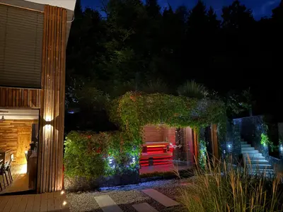 a house with a red bench on a patio at night at Hrdlička Slapy Chalot in Buš