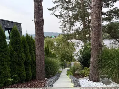 a walkway between two trees in a garden at Hrdlička Slapy Chalot in Buš