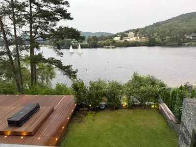 a view of a lake with a boat in the water at Hrdlička Slapy Chalot in Buš