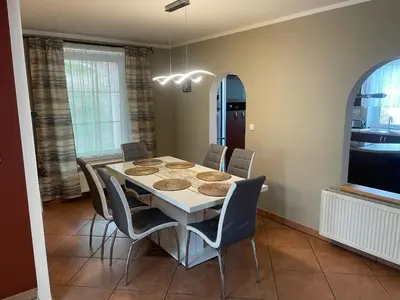 a dining room with a white table and chairs at Rodinný dům Divišov u Benešova, Na Spravedlnosti 276 in Vlašim