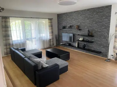 a living room with a couch and a tv at Rodinný dům Divišov u Benešova, Na Spravedlnosti 276 in Vlašim