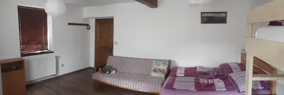 a living room with a couch and a bunk bed at Chalupa u Kahounů in Popovice