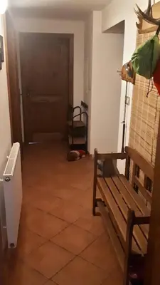 a hallway with a wooden bench and a door at Chalupa u Kahounů in Popovice