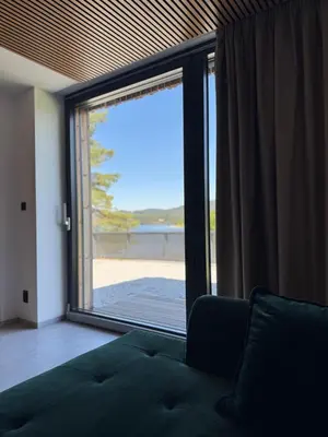 a living room with a large window with a view of the beach at Slapy One&Only in Buš