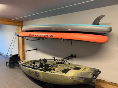 a boat and a surfboard hanging on a wall at Slapy One&Only in Buš