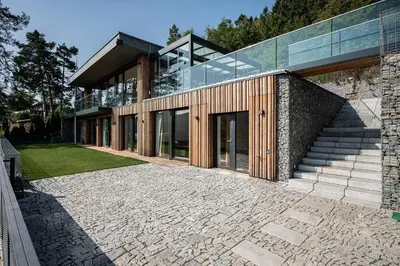 a large house with a stone walkway in front of it at Slapy One&Only in Buš