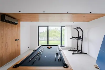 a pool table in a room with a gym at Slapy One&Only in Buš