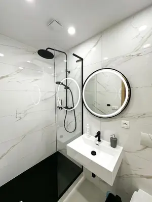 a white bathroom with a sink and a mirror at Krakovka Suites in Prague