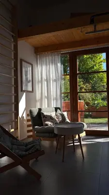 a living room with a couch and a table at Home apartment Konopiště