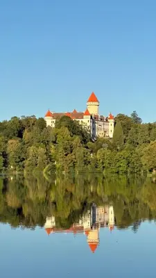 a house on an island in the middle of a lake at Home apartment Konopiště