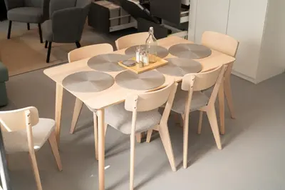 a wooden table with chairs and a table with a bottle on it at New spacious apartment for 6 people, direct entrance in Prague