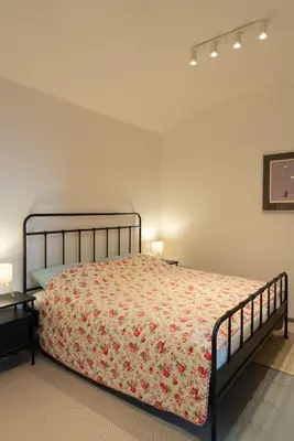 a bedroom with a bed with a floral bedspread at New spacious apartment for 6 people, direct entrance in Prague