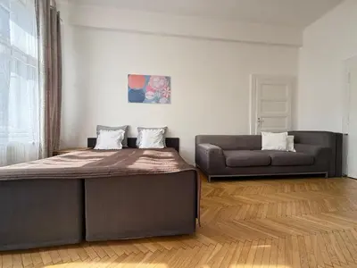a bedroom with a bed and a couch at CUBE Apt in Prague center in Prague