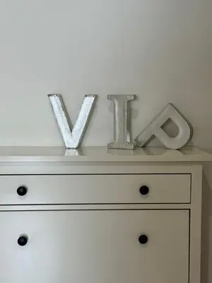 two metal letters sitting on top of a dresser at CUBE Apt in Prague center in Prague
