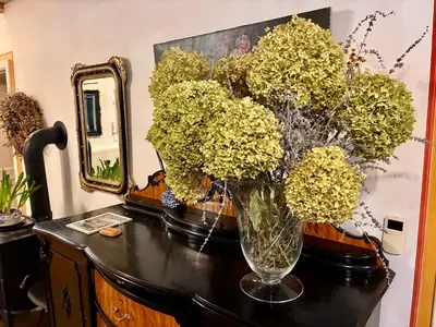 a vase filled with yellow flowers on a table at Villa Riviera in Prague