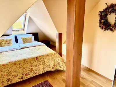 a bedroom with a bed in a attic at Villa Riviera in Prague