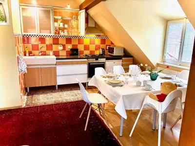 a kitchen with a table with a teddy bear sitting on it at Villa Riviera in Prague