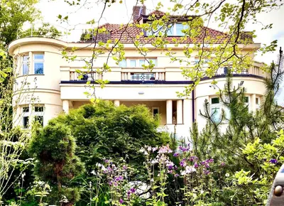 a building with a garden in front of it at Villa Riviera in Prague