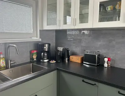 a kitchen counter with a sink and a microwave at Holiday Home Prague Šeberov in Prague