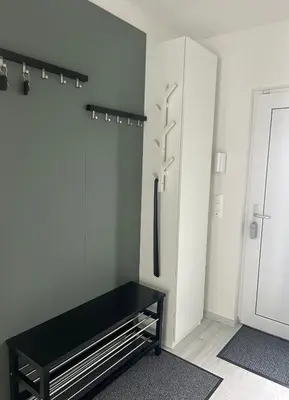 a room with a black bench next to a door at Holiday Home Prague Šeberov in Prague