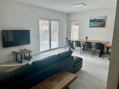a living room with a couch and a table with chairs at Holiday Home Prague Šeberov in Prague