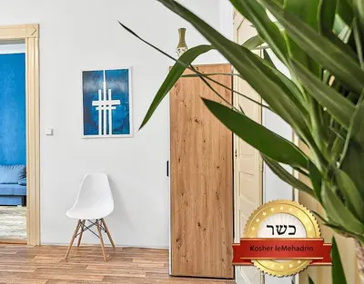 a room with a clock and a cross on the wall at Stylish Apartment near Wenceslas Square in Prague