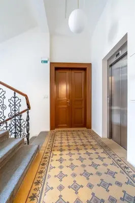 a hallway with a door and a tile floor at City Center Deer Suite in Prague