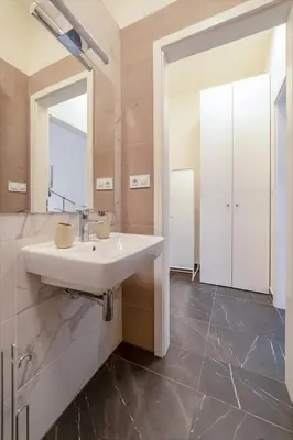 a bathroom with a sink and a mirror at City Center Deer Suite in Prague