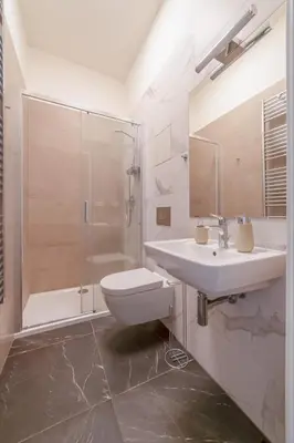 a bathroom with a sink and a shower and a toilet at City Center Deer Suite in Prague