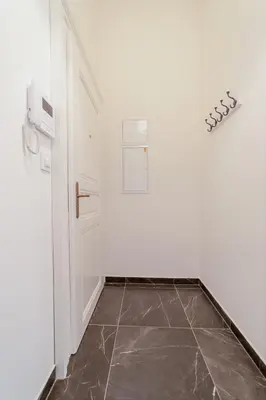 a hallway with a door and a tile floor at City Center Deer Suite in Prague