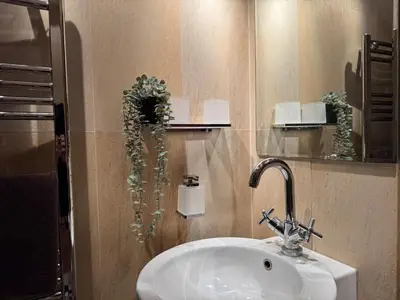 a bathroom with a sink and a mirror at Historic Arch Apartment - Karlova Street in Prague