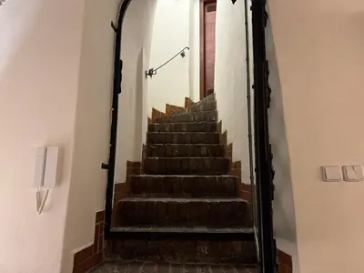 a stairway leading up to a door in a building at Historic Arch Apartment - Karlova Street in Prague