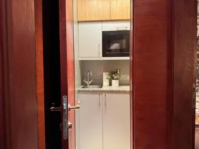 a kitchen with a sink and a microwave at Historic Arch Apartment - Karlova Street in Prague