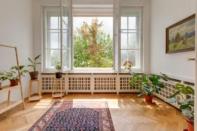 an empty room with a large window and plants at Large Garden Villa Suite Business-Leisure-Sports in Prague