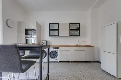 a kitchen with a table and a washer and dryer at Large Garden Villa Suite Business-Leisure-Sports in Prague