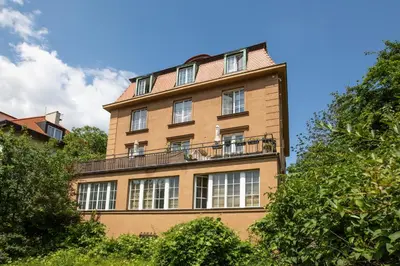a tall building with a balcony on top of it at Large Garden Villa Suite Business-Leisure-Sports in Prague