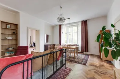 a living room with a couch and a table at Large Garden Villa Suite Business-Leisure-Sports in Prague