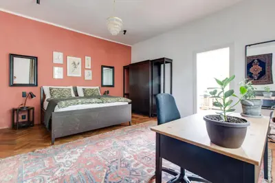a bedroom with a bed and a desk and a table with a plant at Large Garden Villa Suite Business-Leisure-Sports in Prague