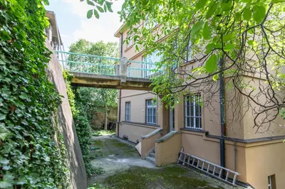 a bridge over an alley between two buildings at Large Garden Villa Suite Business-Leisure-Sports in Prague