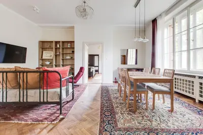 a dining room and living room with a table and chairs at Large Garden Villa Suite Business-Leisure-Sports in Prague