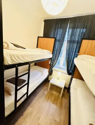 two bunk beds in a room with a window at Levné ubytování in Prague