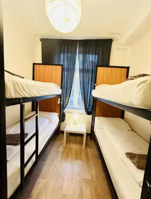 two bunk beds in a room with a window at Levné ubytování in Prague