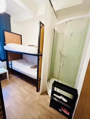 a small room with a bunk bed and a mirror at Levné ubytování in Prague