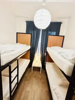 a room with two bunk beds and a chandelier at Levné ubytování in Prague