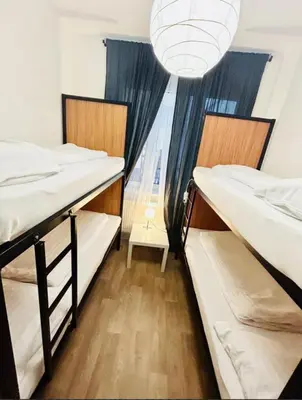 two bunk beds in a dorm room with a window at Levné ubytování in Prague