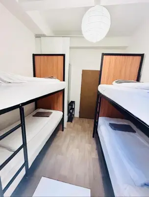 a room with two bunk beds and a pendant light at Levné ubytování in Prague