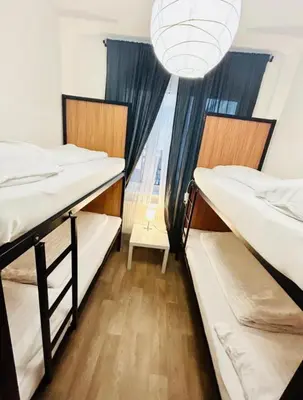 two bunk beds in a dorm room with a window at Levné ubytování in Prague