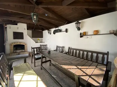 a room with a wooden table and a fireplace at Chalupa u Marušky